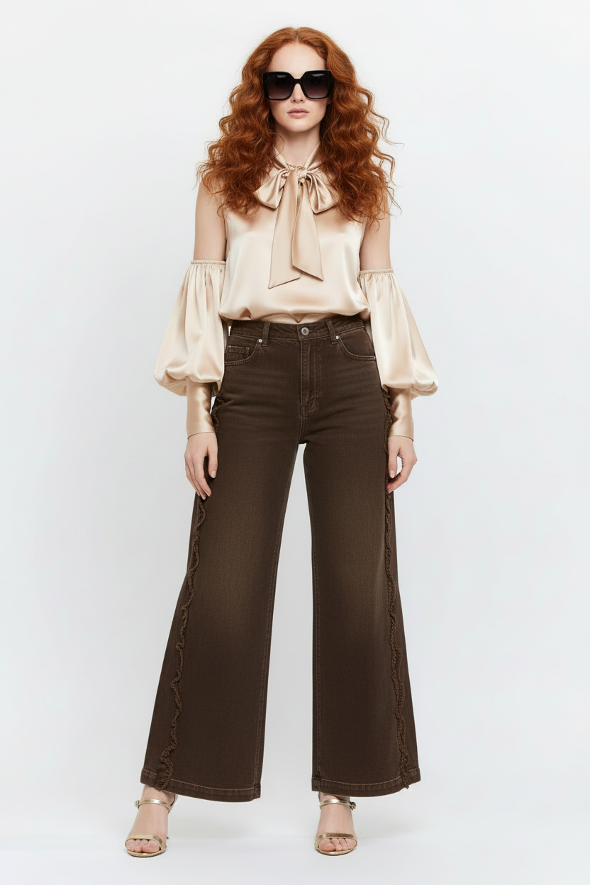 Beciga model wearing washed brown denim jeans with raw seam details