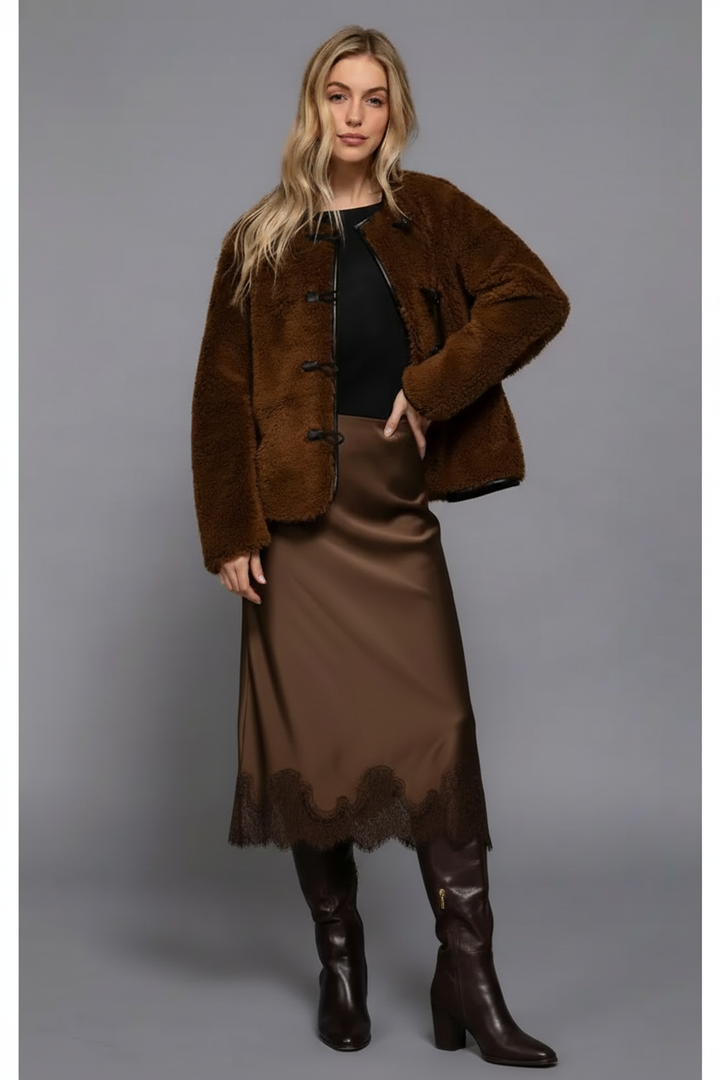 Blonde model in faux fur jacket and satin skirt