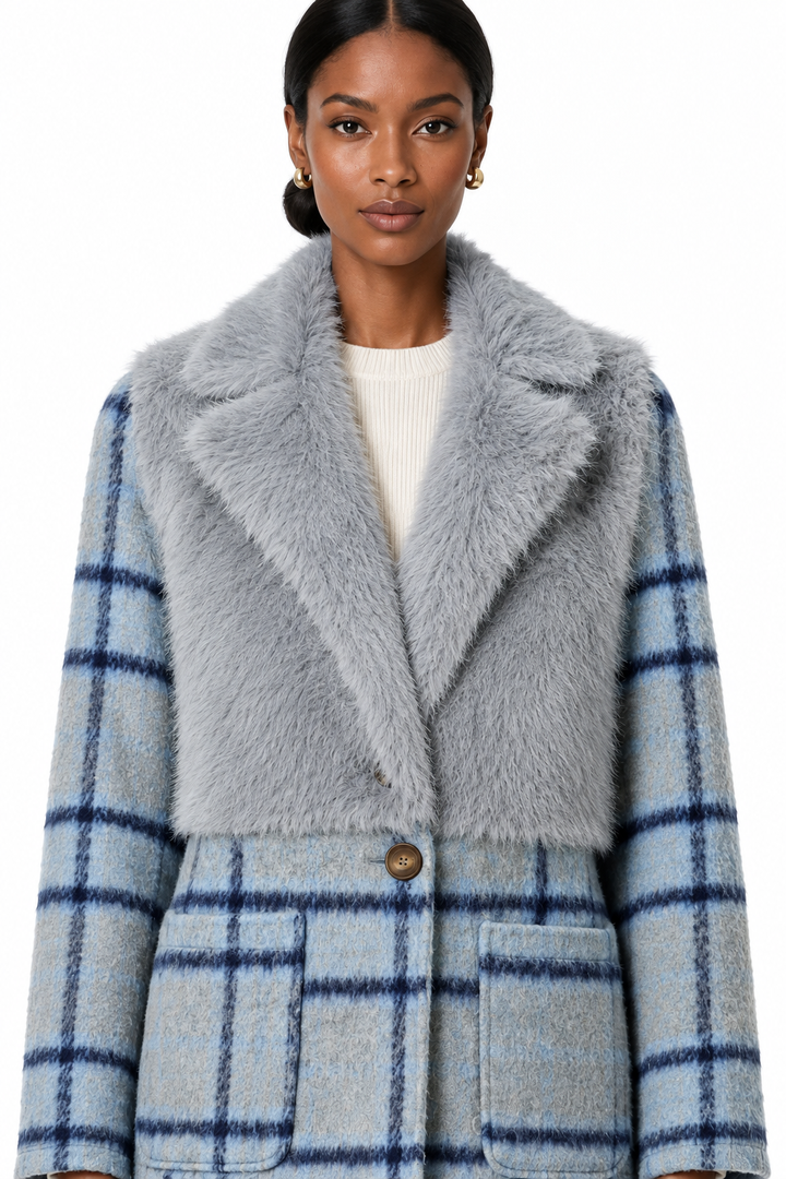 Close-up of the model wearing the cloudy blue mixed-media coat