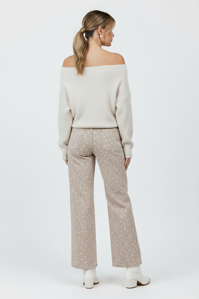 Cream off-shoulder sweater back view with white boots and white background