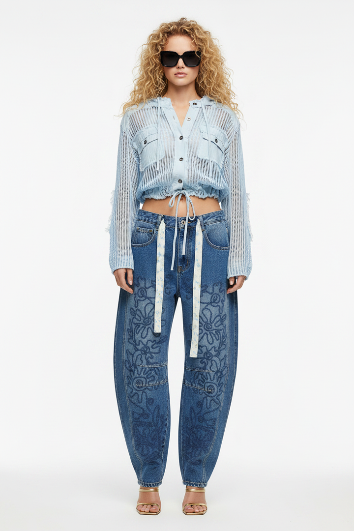 Curly blonde model, front, true barrel jeans + blue knit jacket