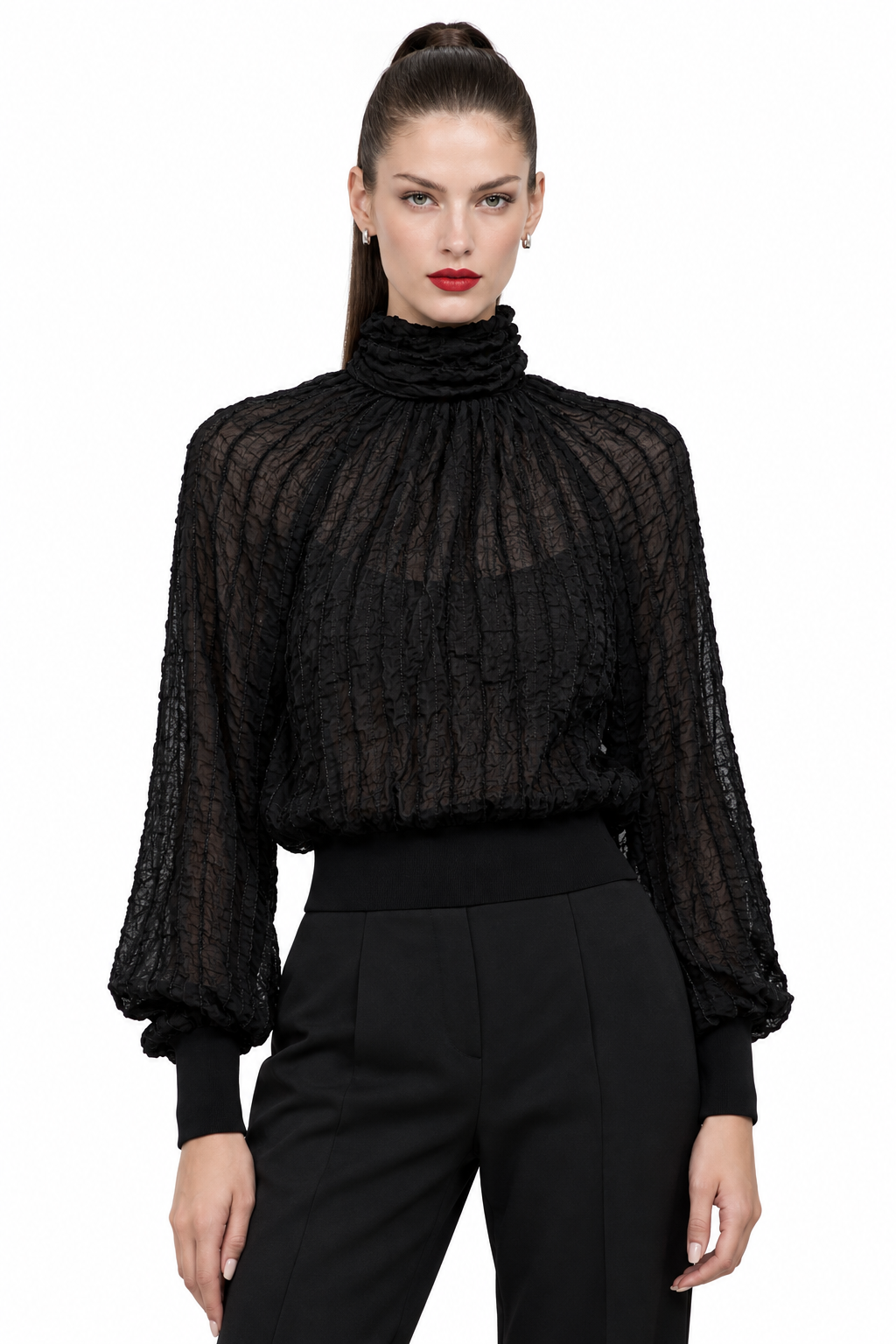 Sloane wearing black semi-sheer textured turtleneck blouse, front view