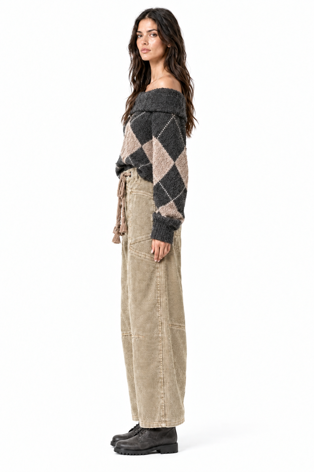 Side profile of camel corduroy barrel pants on brunette model with charcoal combat boots