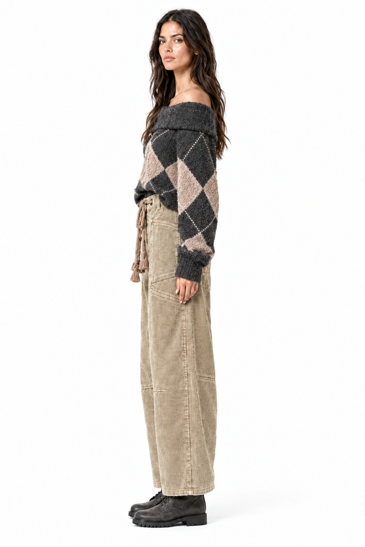 Side profile of camel corduroy barrel pants on brunette model with charcoal combat boots