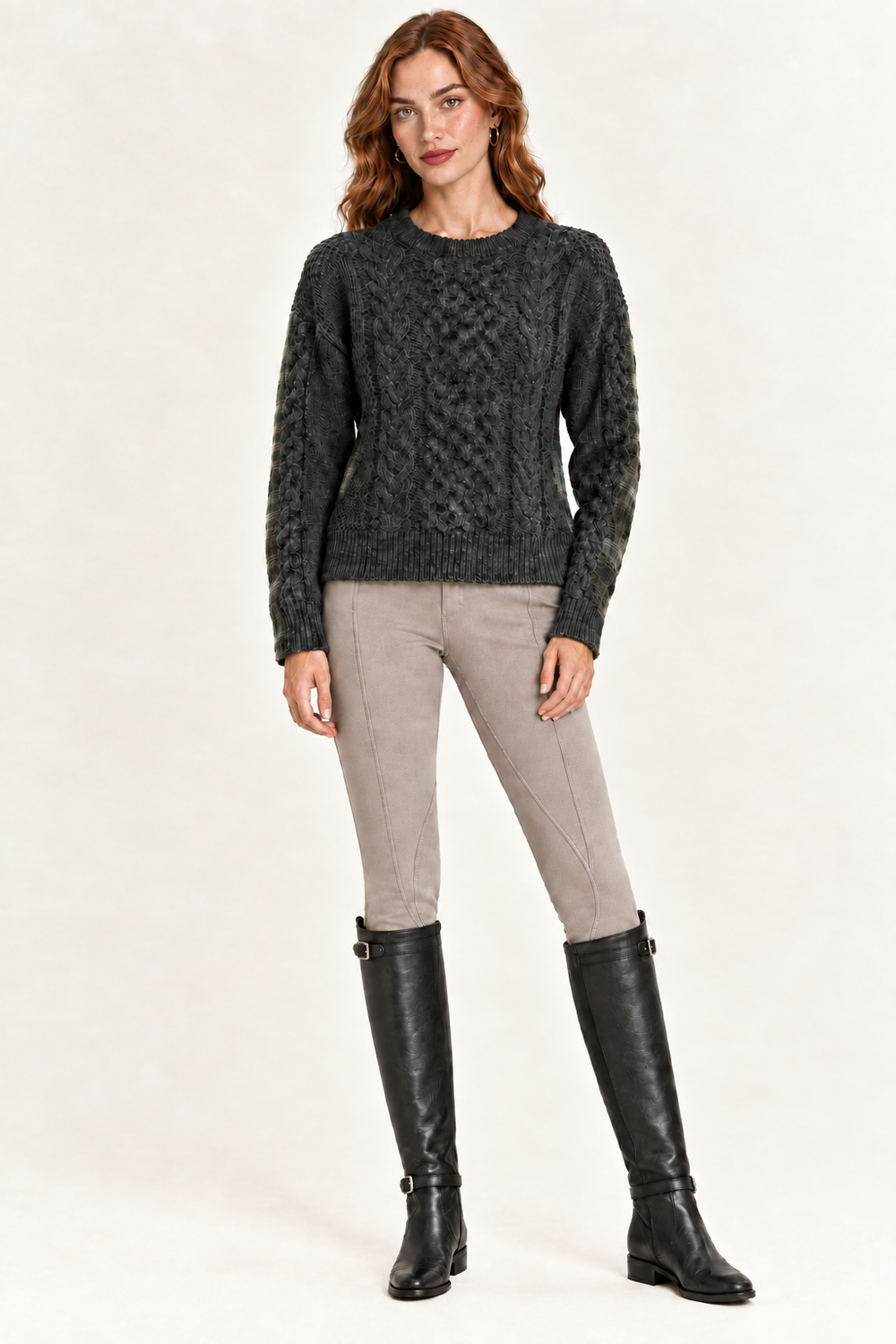 Rowan wearing charcoal cable-knit front sweater with taupe riding pants and black boots