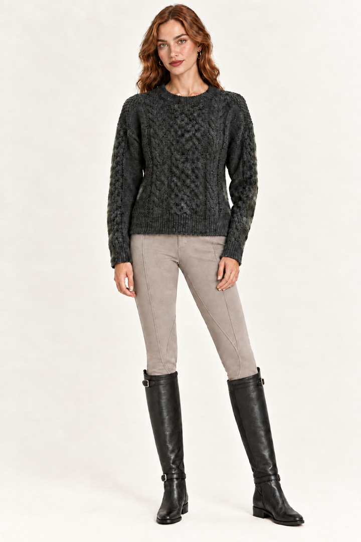 Rowan wearing charcoal cable-knit front sweater with taupe riding pants and black boots