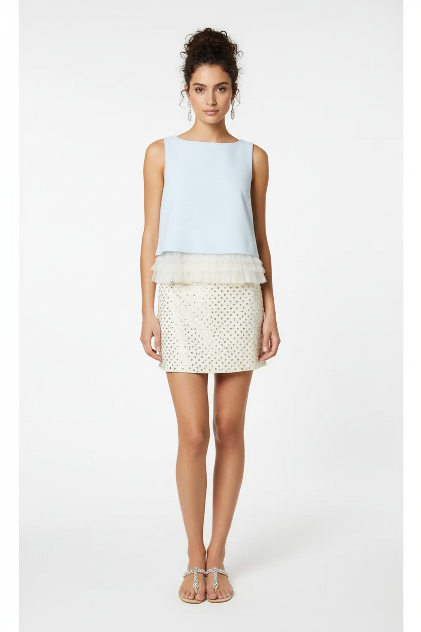 Baby blue sleeveless ruffle hem top - front view with dark curly messy bun model on white background