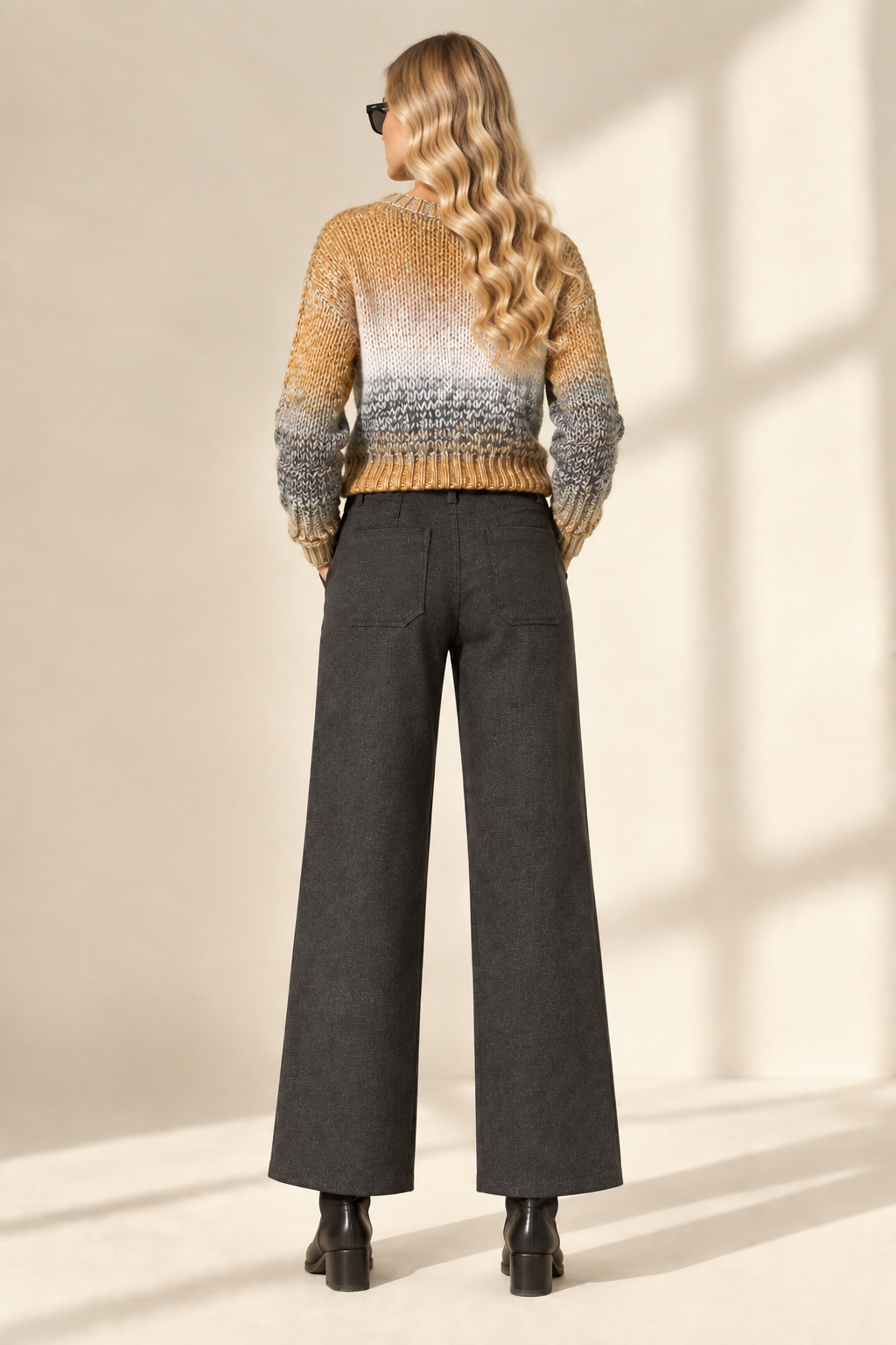 Back view of Tracey wearing charcoal Ponte Fabric Crop Pants and color-block sweater