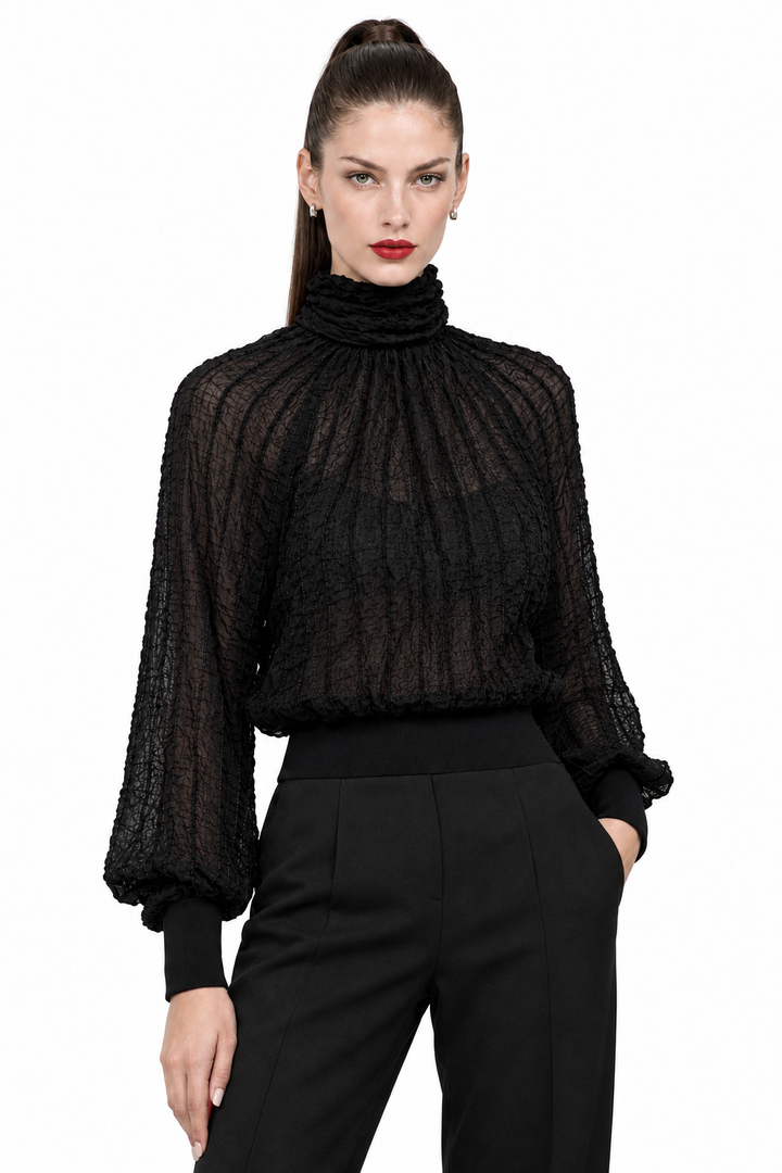 Sloane wearing black semi-sheer textured turtleneck blouse, editorial lifestyle view