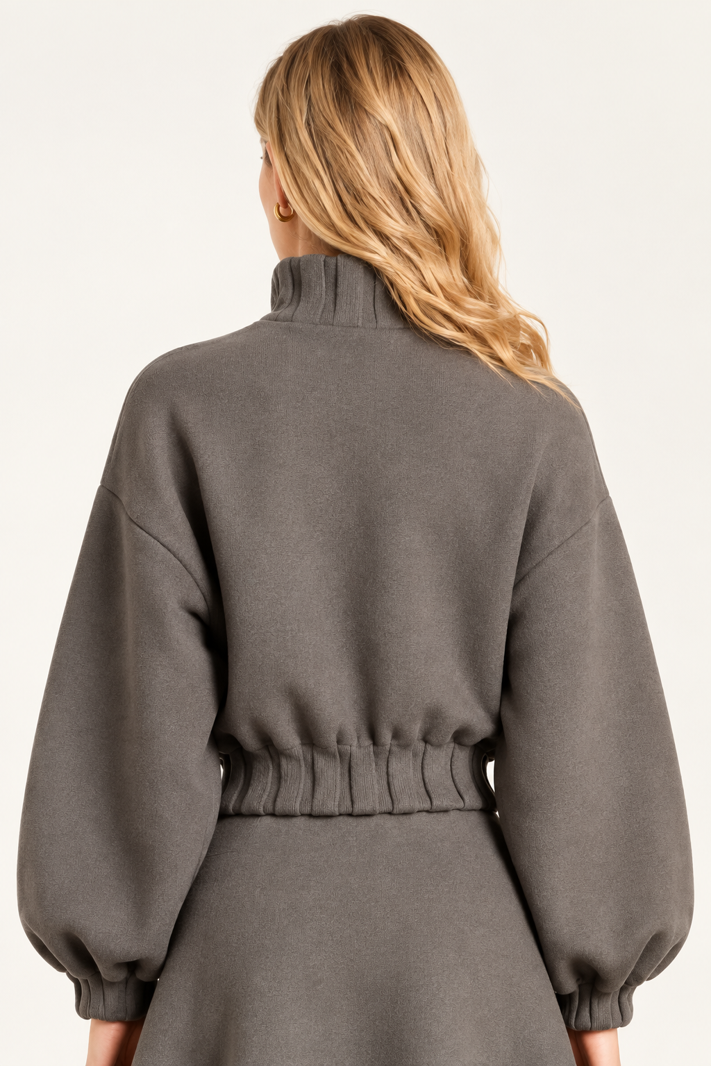 Back view of Maggie wearing Dark Stone High Neck Button Closure Jacket showing gathered ribbed hem