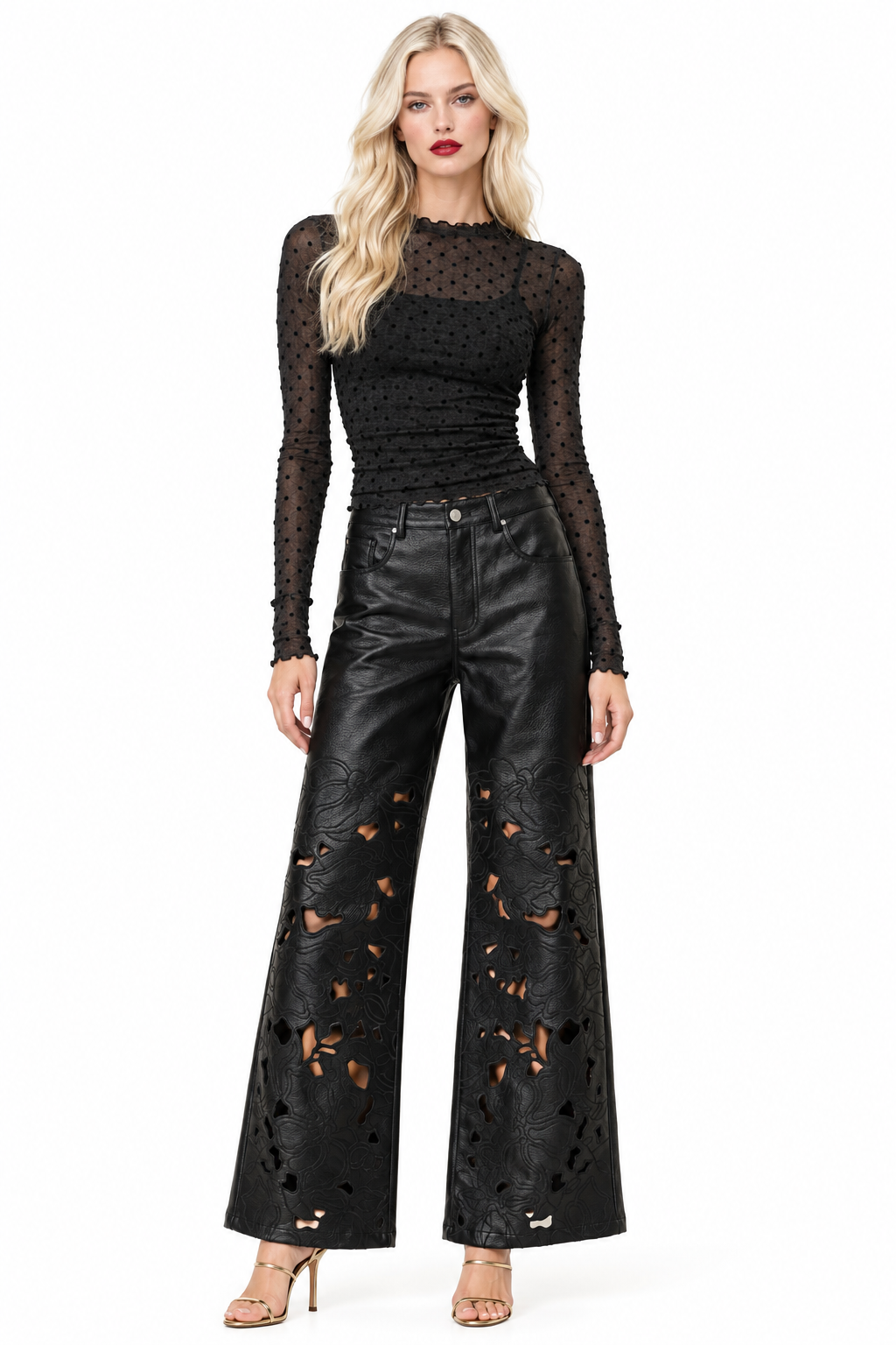 Tiffany wearing black polka-dot sheer top and black vegan-leather floral-cutout wide-leg pants with gold heels, front view