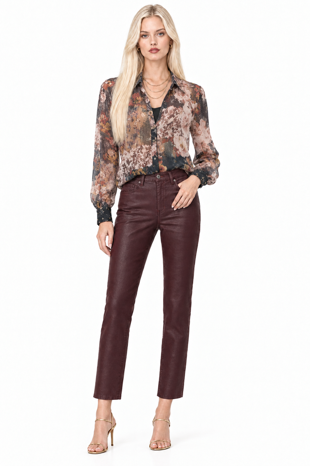 Tiffany wearing deep Winery high-rise slim-straight coated pants with a sheer floral blouse and layered gold necklaces, front view