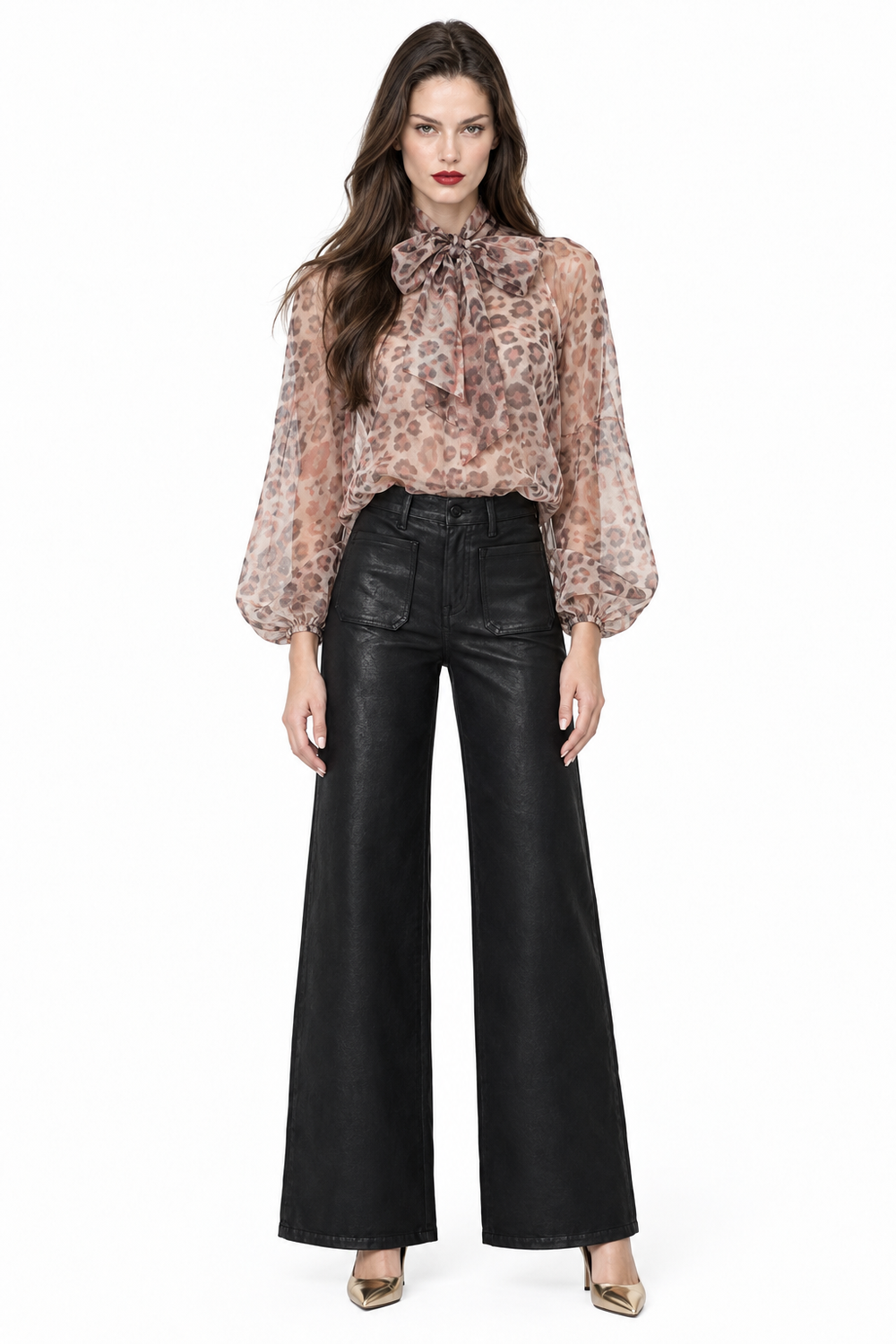 Sloane with dark hair down wearing black coated patch-pocket wide-leg jeans, printed bow blouse and gold pumps, front view