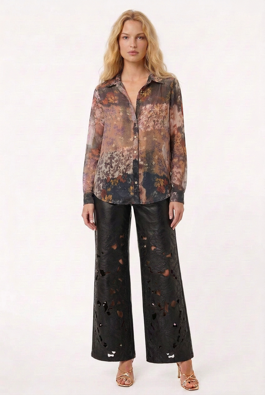Tricia wearing the Sheer Floral Print Blouse fully untucked with black floral-cutout pants and gold heels, front view