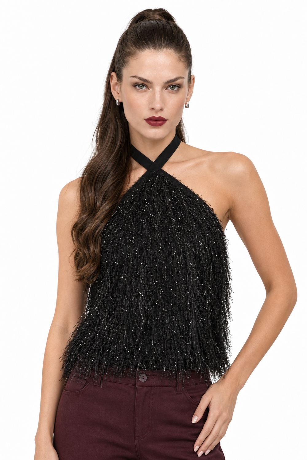 Sloane with half-up hair and wine lipstick wearing black crisscross fringe halter top and wine pants, front view