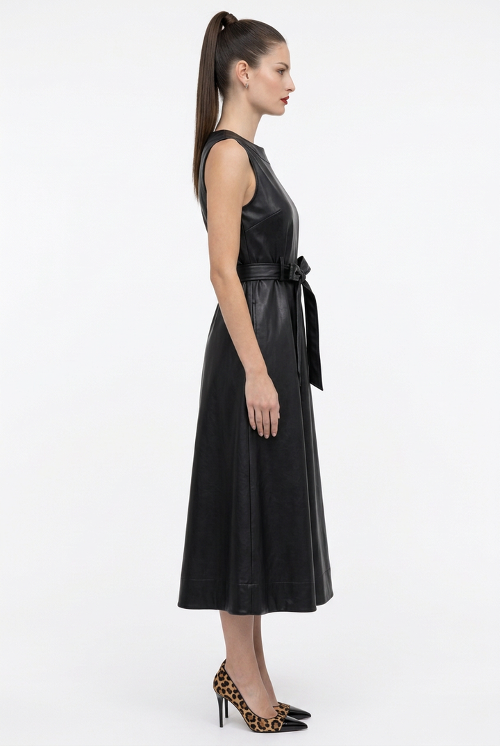 Side view of black faux leather sleeveless belted dress on Sloane
