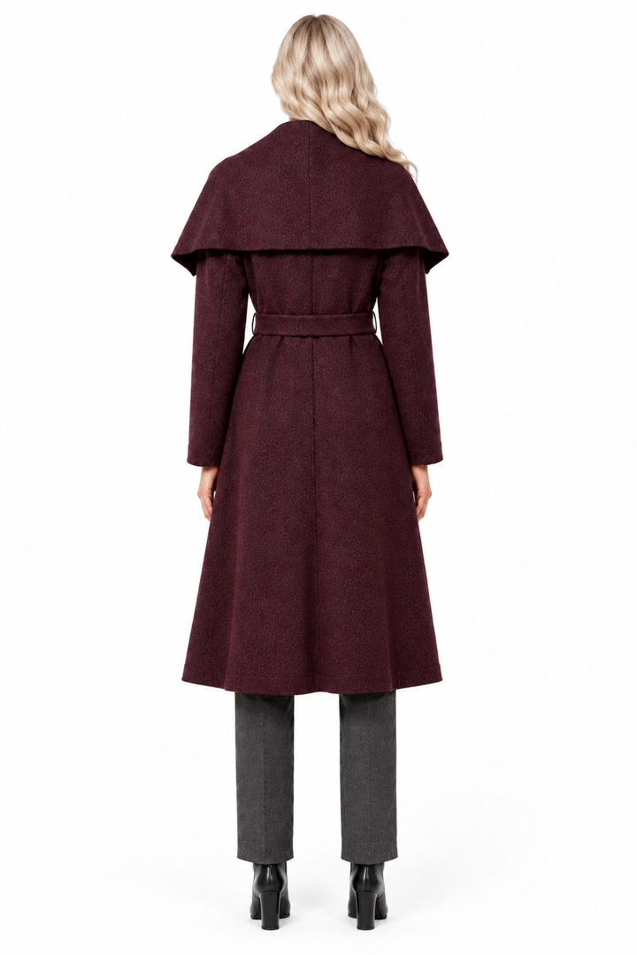 Blonde model in burgundy shawl collar long coat, charcoal trousers and black ankle boots, back view