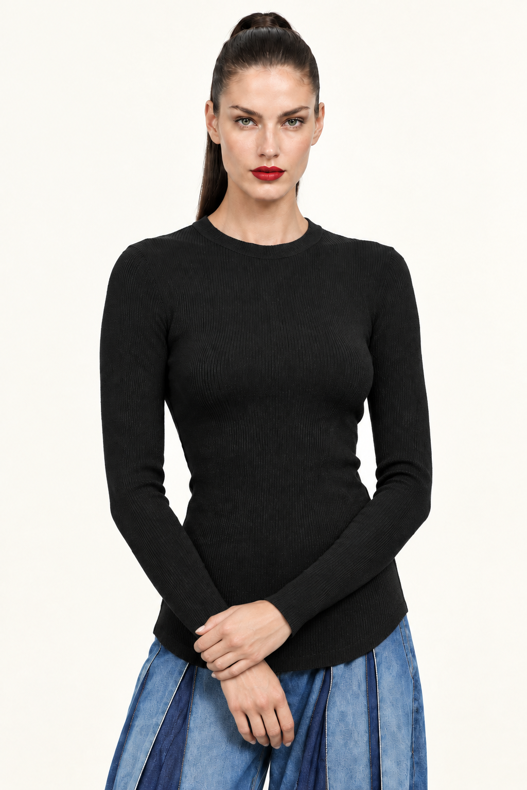 Sloane angled front waist-up view showing black ribbed long sleeve top and curved hem