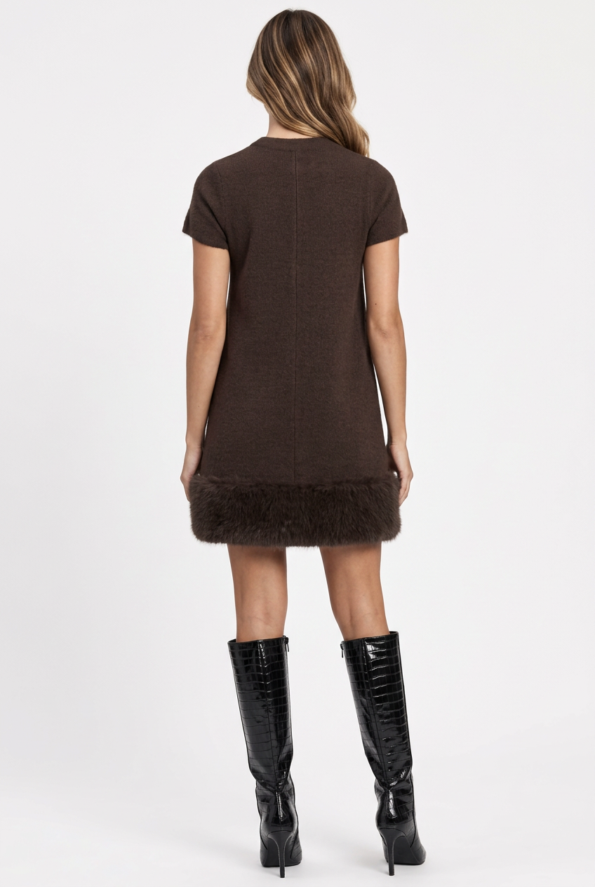 Camille wearing the brown faux fur trimmed mini dress with black patent croc-texture knee-high boots, back view