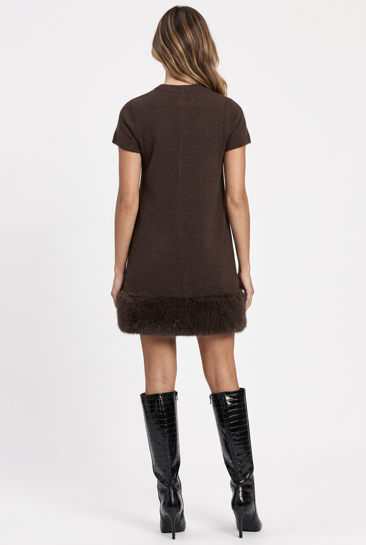 Camille wearing the brown faux fur trimmed mini dress with black patent croc-texture knee-high boots, back view