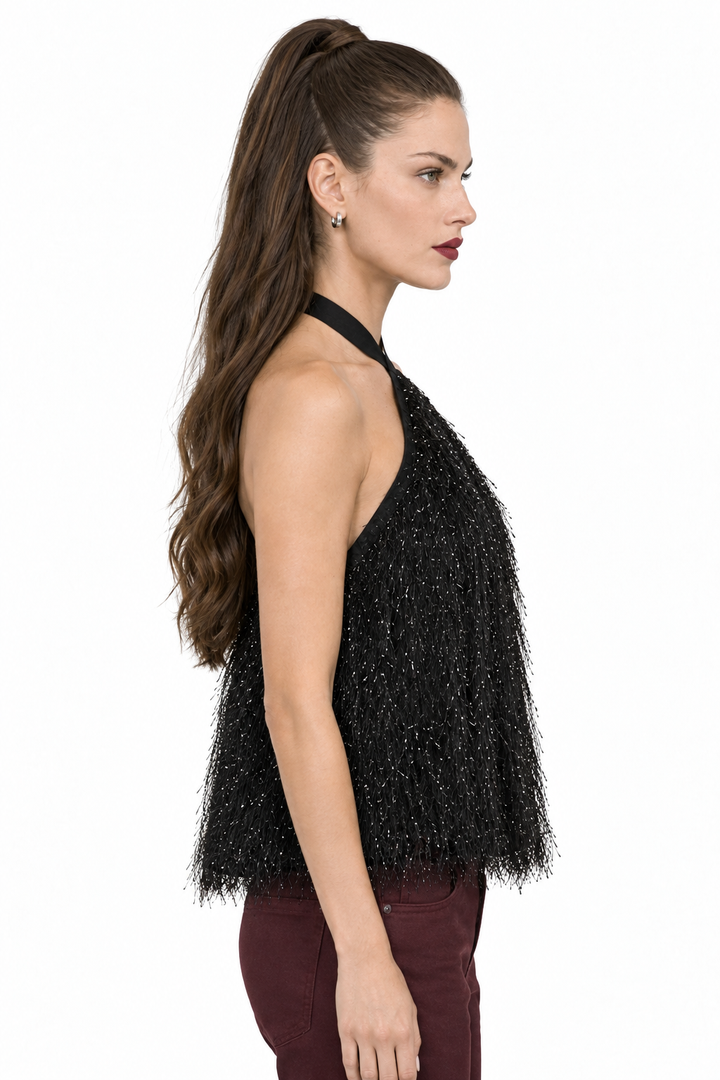 Side view of Sloane wearing black crisscross halter feather-like fringe top with wine pants