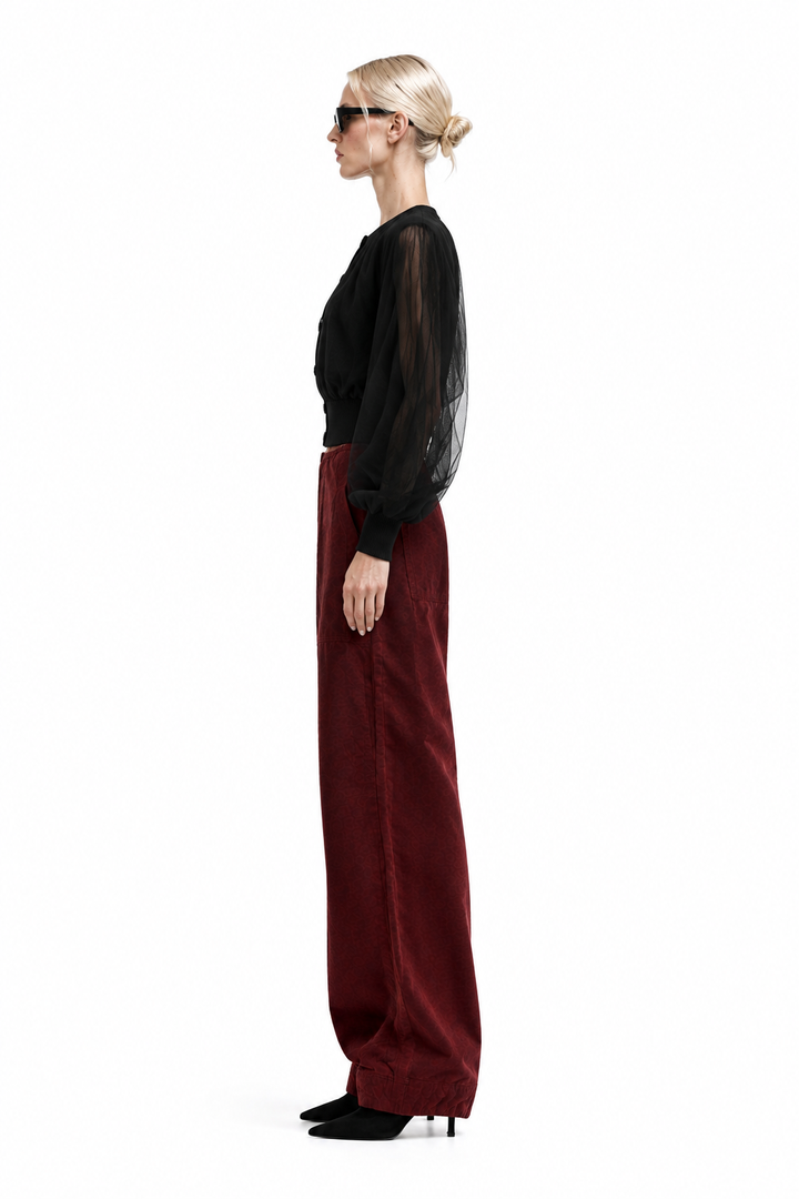 Side profile of Vino corduroy barrel pants styled with black top and black ankle boots