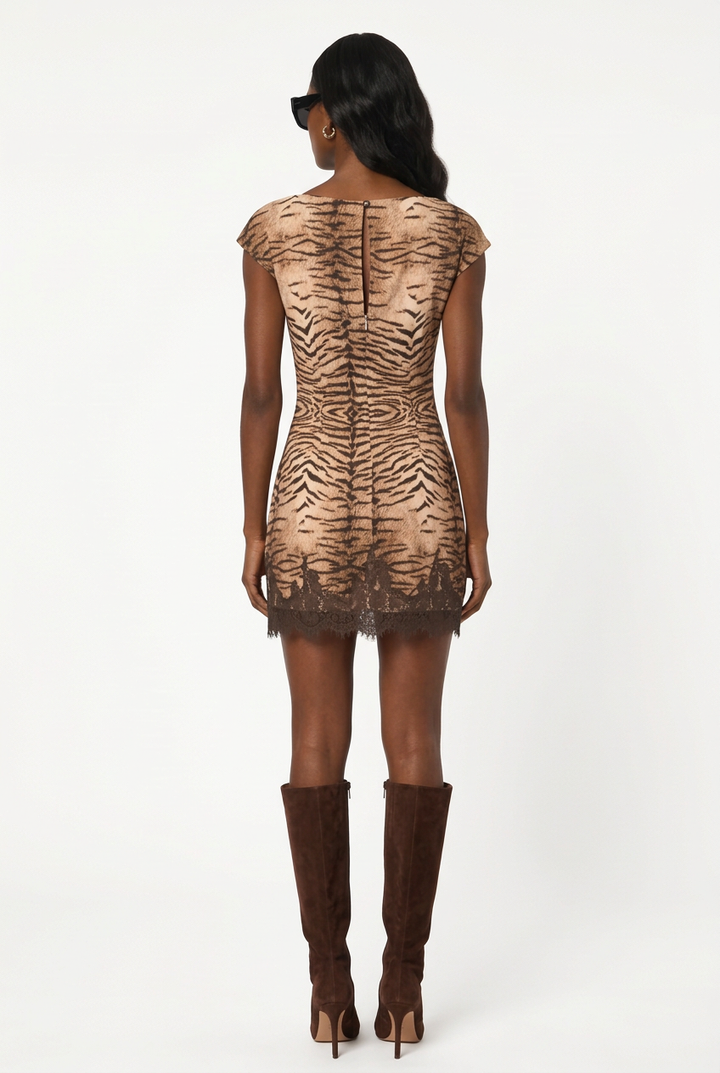 Cici wearing the taupe tiger-print lace-hem mini dress with brown suede knee-high boots, back view