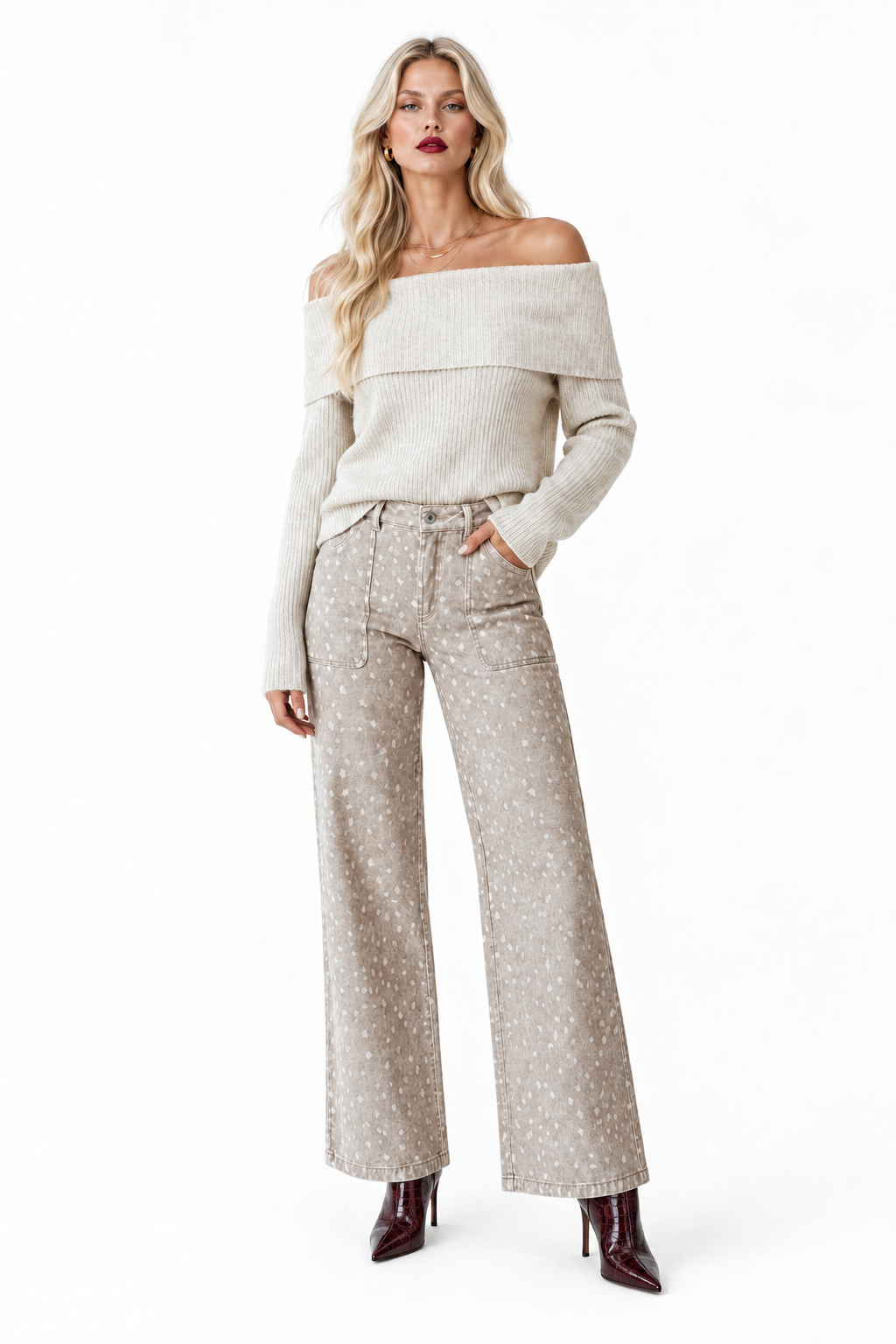 Model in cream off-shoulder sweater and patterned wide-leg pants with dark wine crocodile-embossed boots, front view