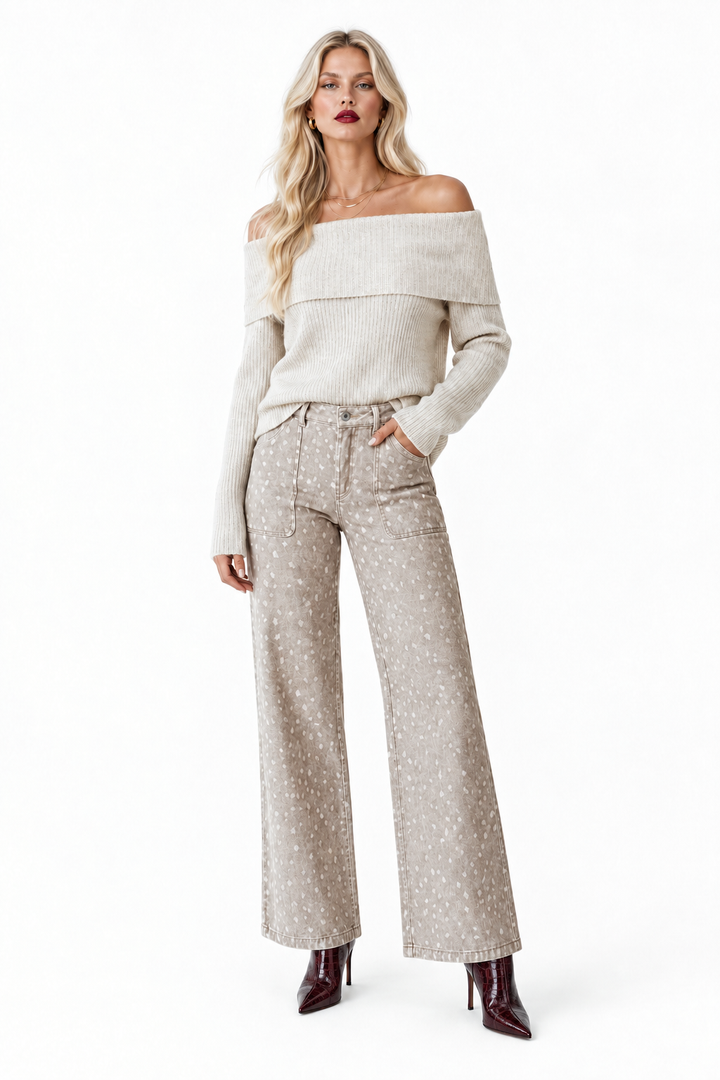 Model in cream off-shoulder sweater and patterned wide-leg pants with dark wine crocodile-embossed boots, front view