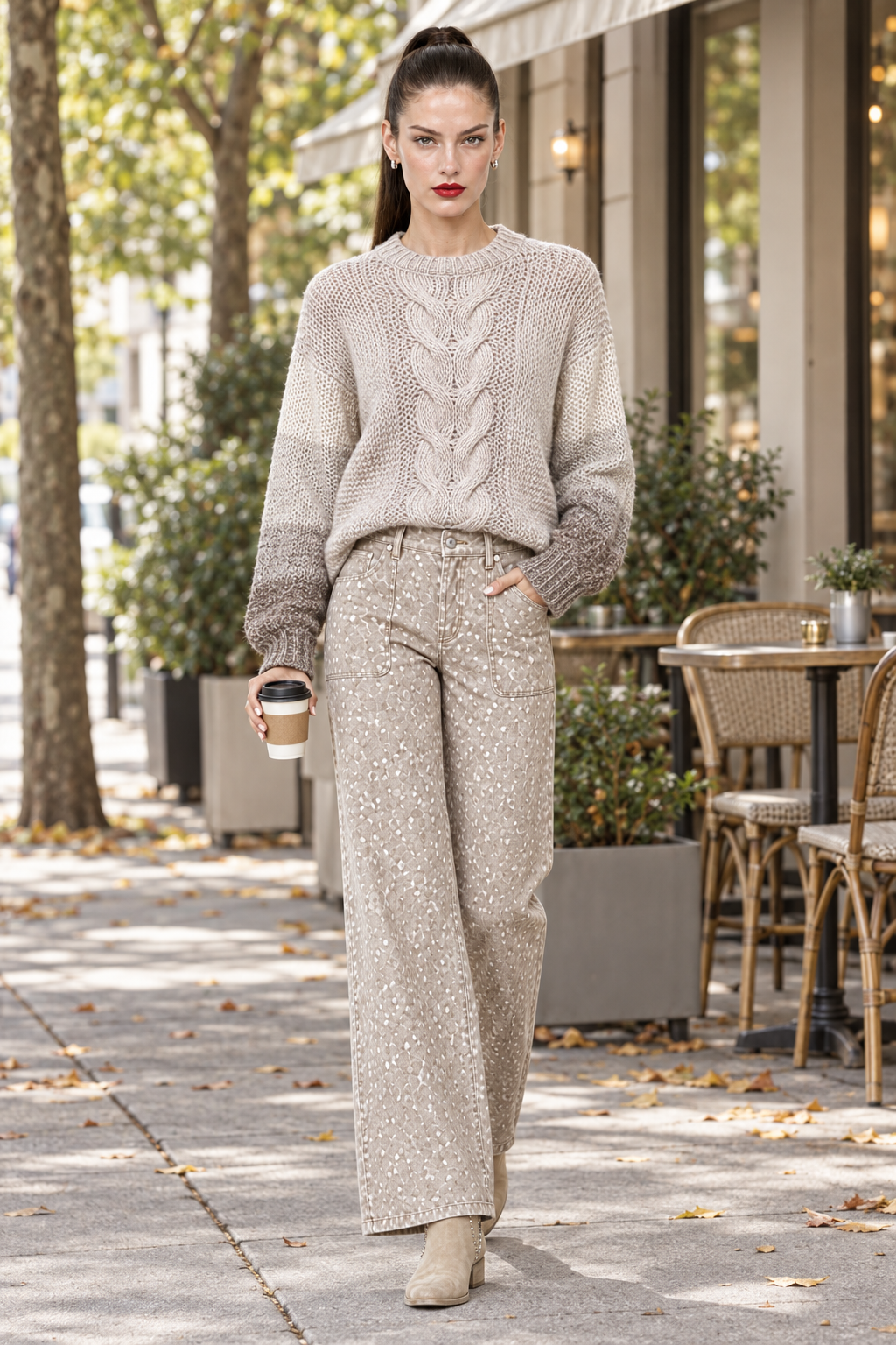 Sloane strolling with a coffee in the Color Block Cable Knit Sweater and Fantastic Fawn jeans