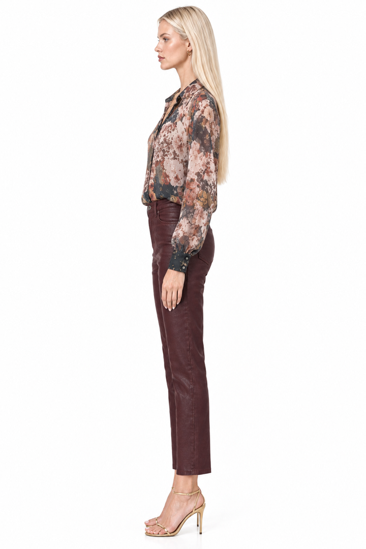 Side profile of Tiffany wearing Winery coated slim-straight ankle pants with floral blouse