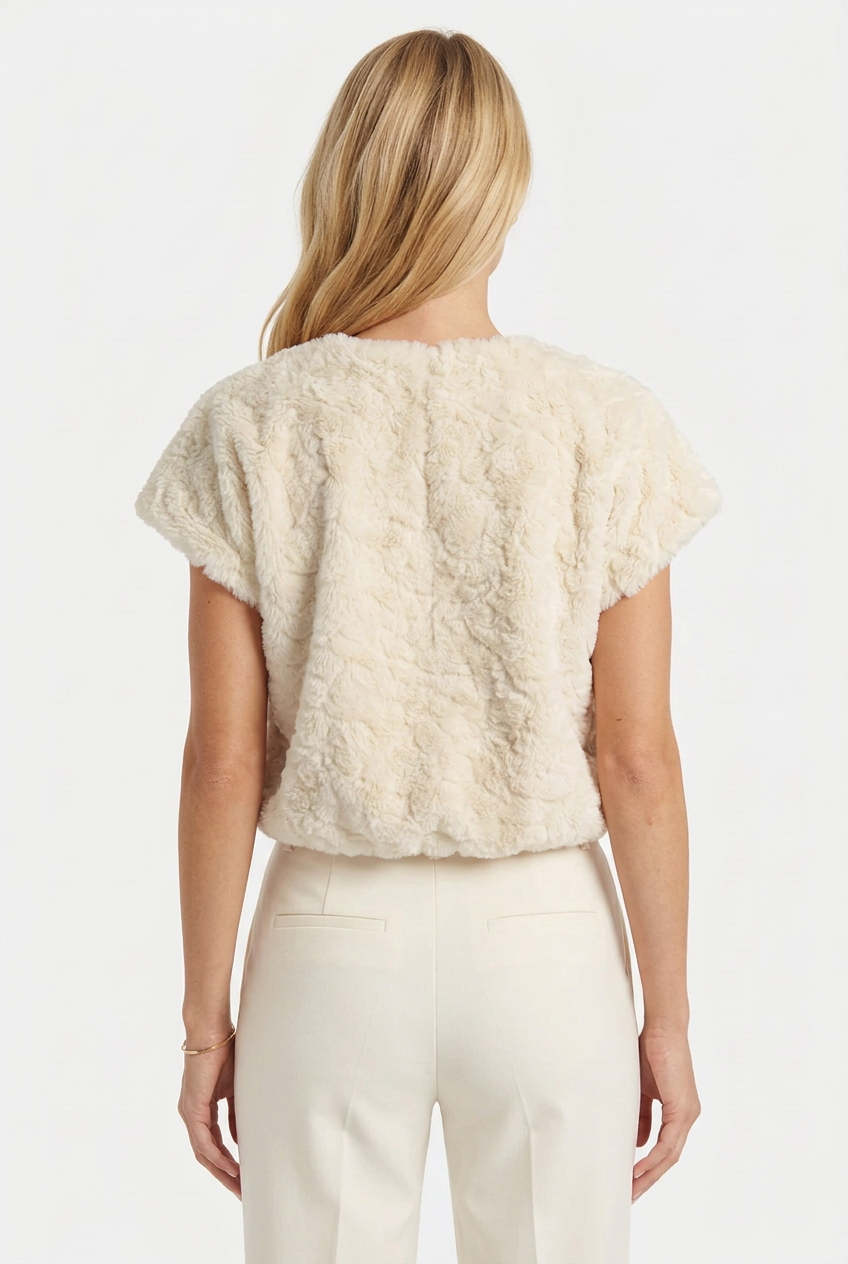 Back view of Tricia wearing the cream plush textured faux fur top.