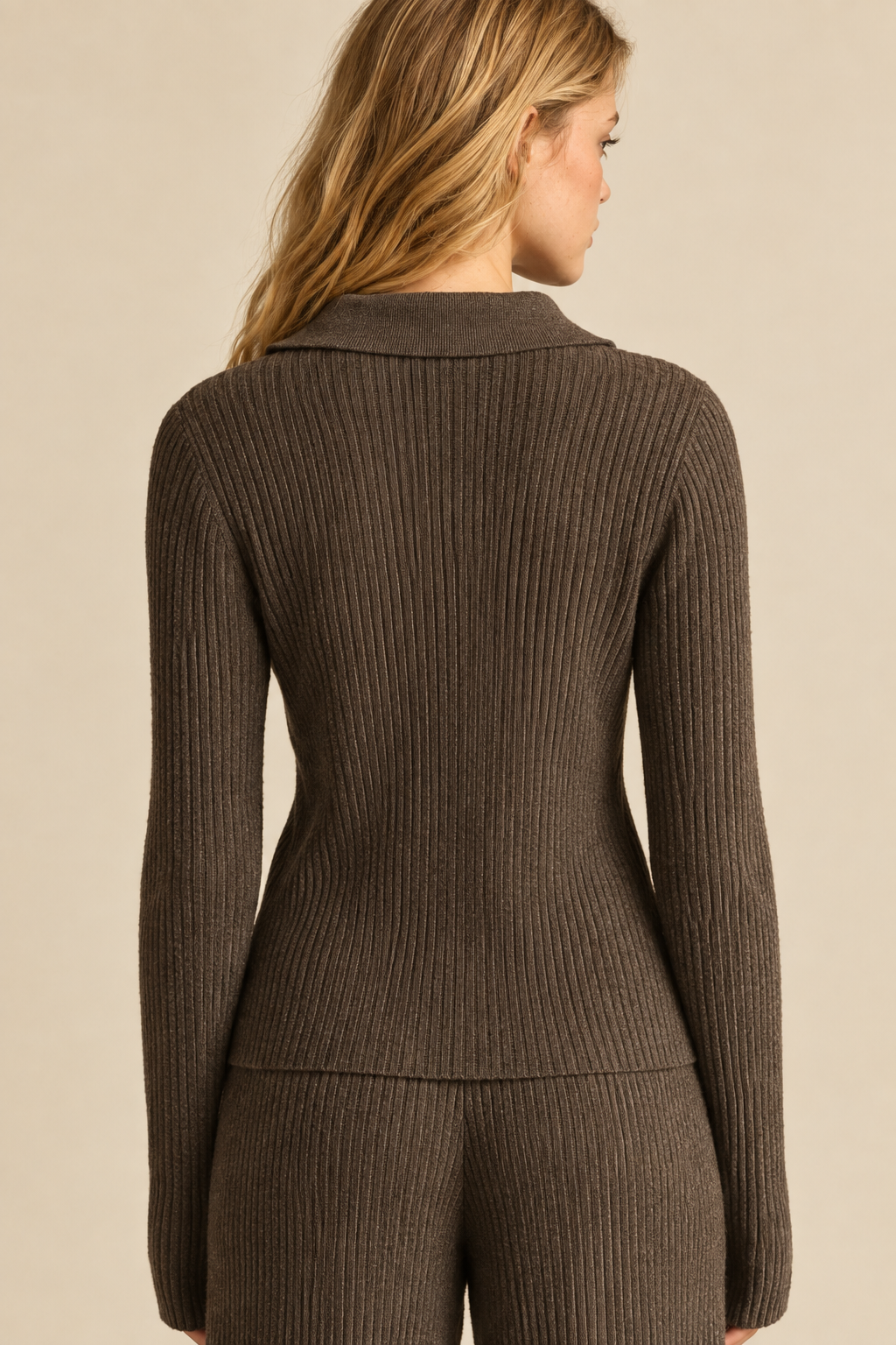 Back view of Tricia wearing the Espresso Zip Up Ribbed Knit Top, showing vertical ribbing and collar