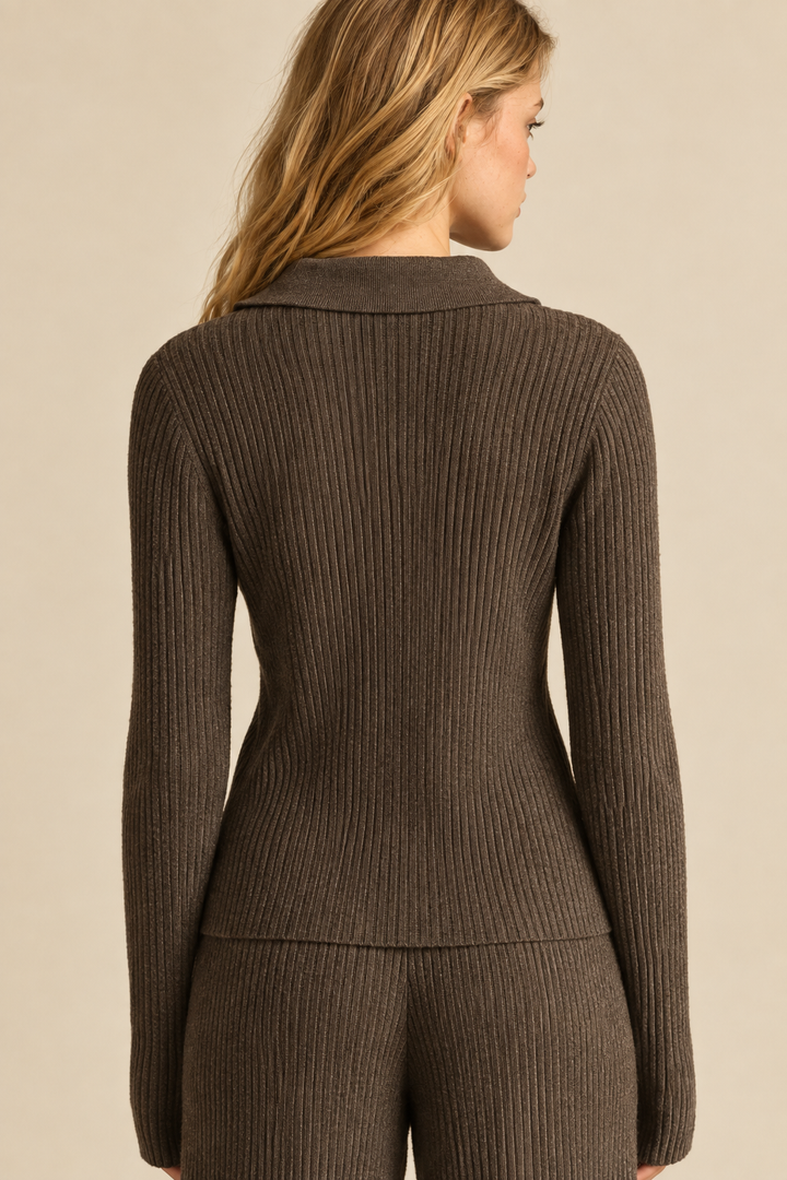 Back view of Tricia wearing the Espresso Zip Up Ribbed Knit Top, showing vertical ribbing and collar