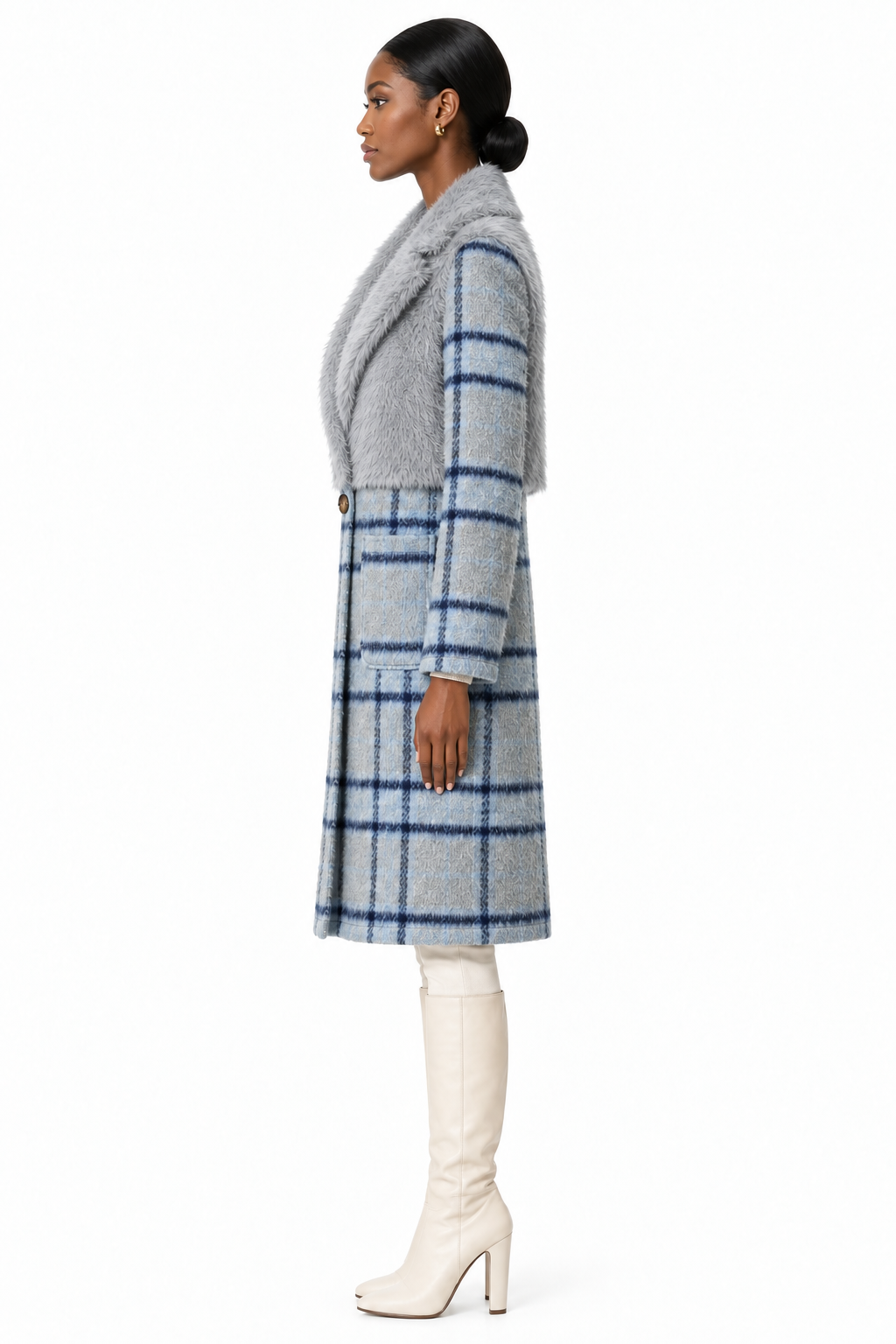 Model wearing cloudy blue faux-fur and plaid coat with cream knee-high boots, side view