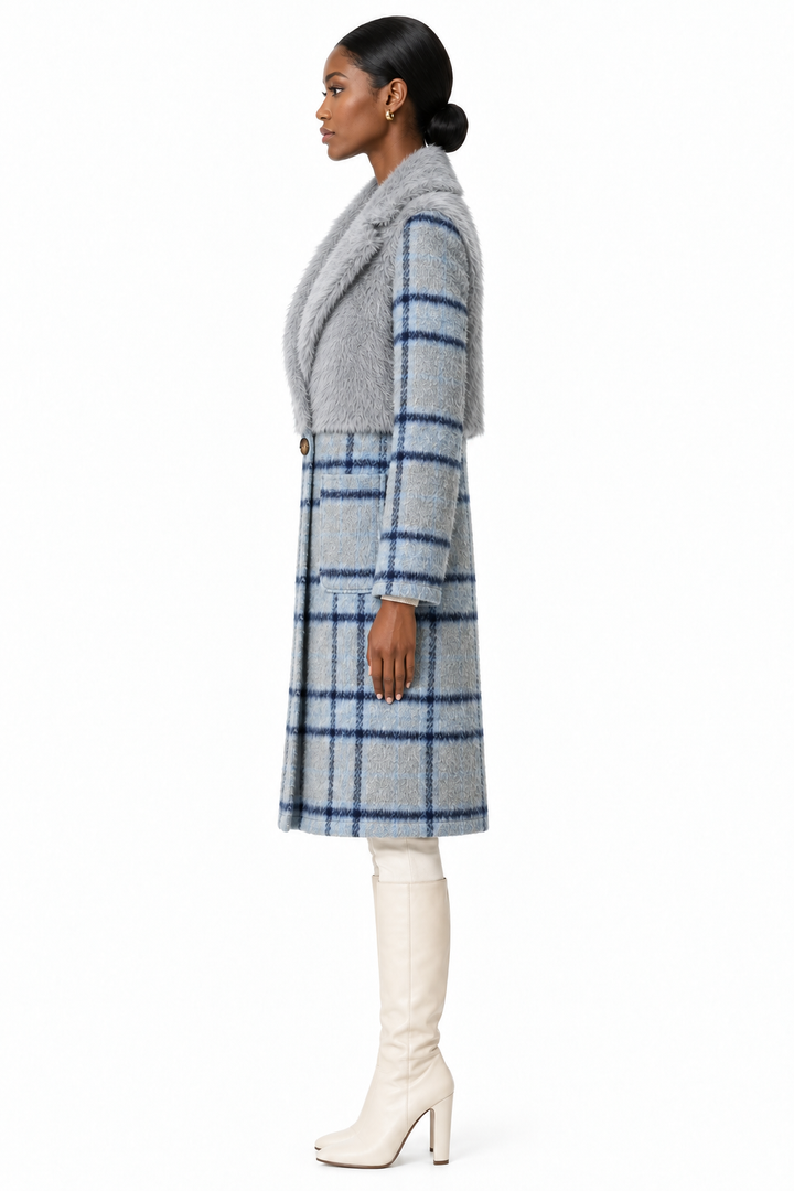 Model wearing cloudy blue faux-fur and plaid coat with cream knee-high boots, side view