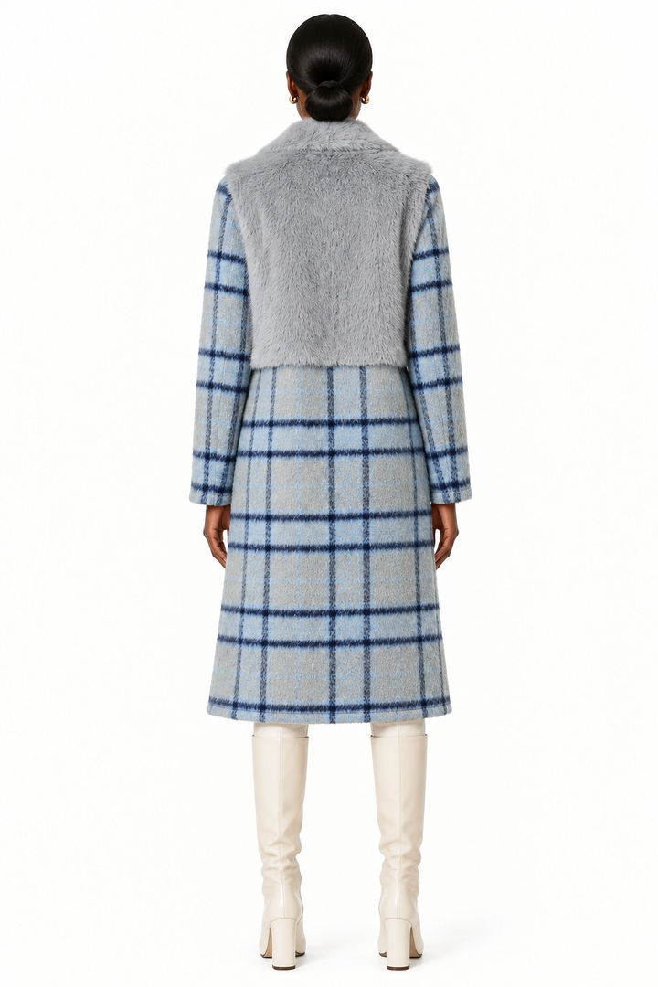 Model wearing cloudy blue plaid and faux-fur mixed-media long coat with cream knee-high boots, back view