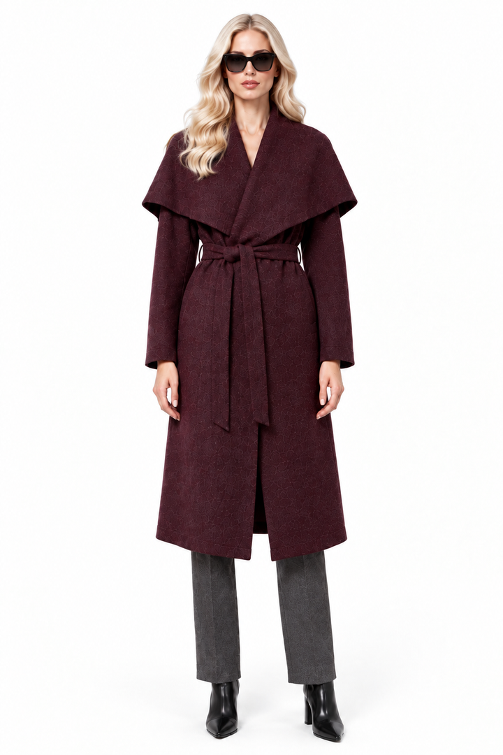 Blonde model in burgundy shawl collar long coat, charcoal trousers and black ankle boots, front view