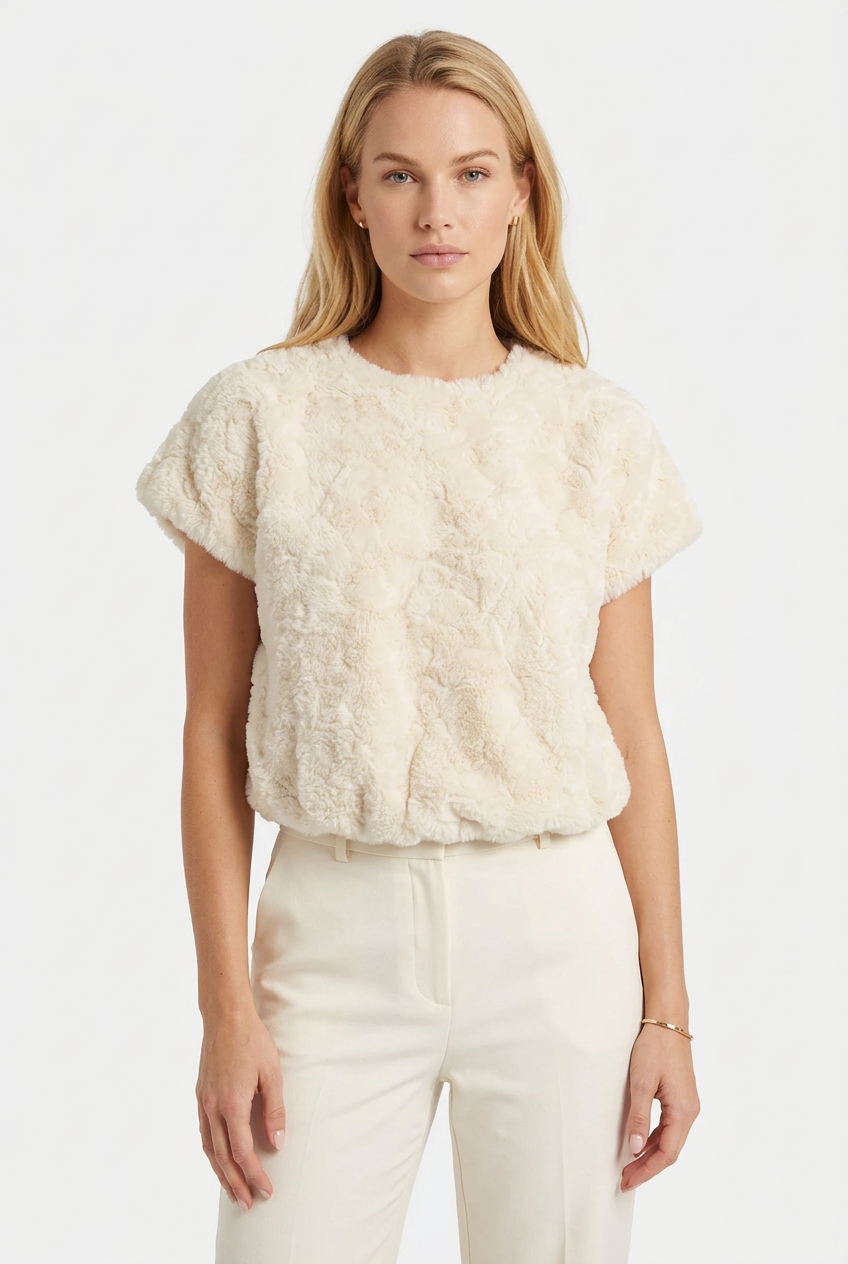 Tricia modeling the cream plush textured faux fur top without glasses.