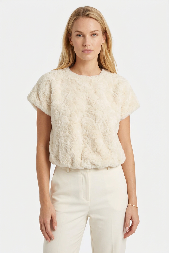 Tricia modeling the cream plush textured faux fur top without glasses.