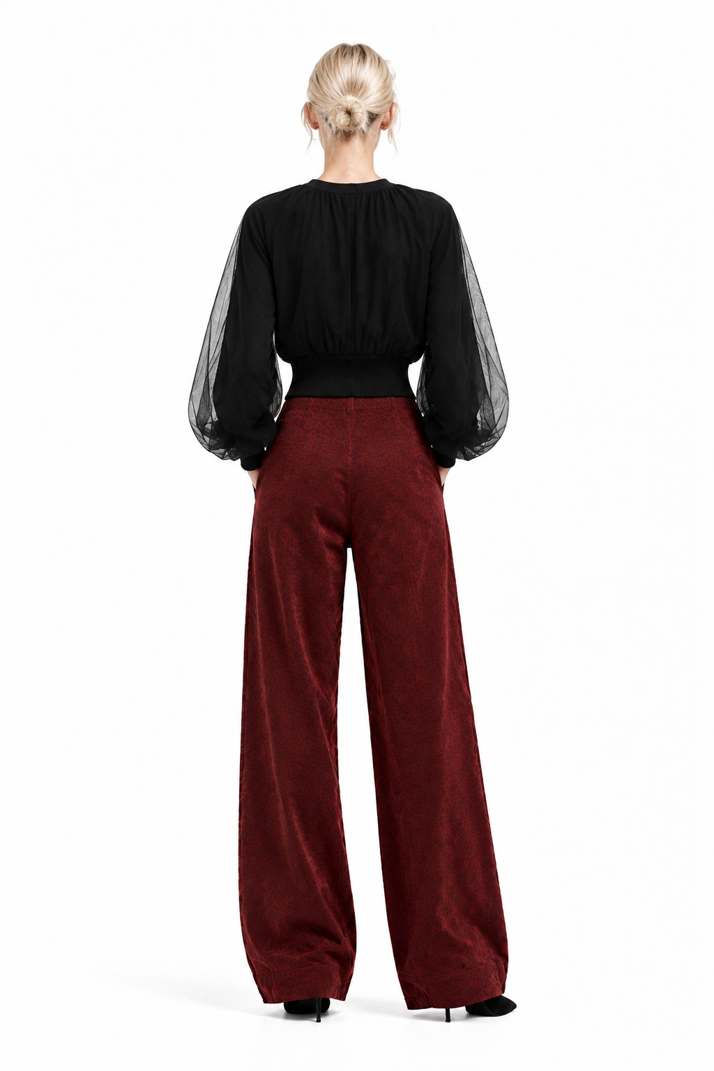 Back view of Vino corduroy barrel pants on blonde model with black top and black ankle boots