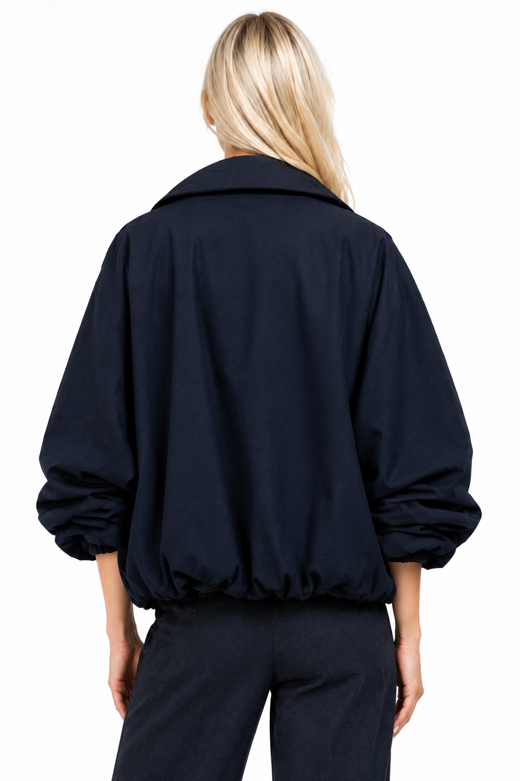 Blonde model wearing navy funnel-neck bomber jacket, back view
