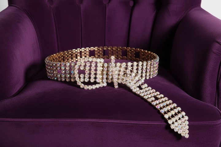 Rhinestone belt spread out on purple velvet chair