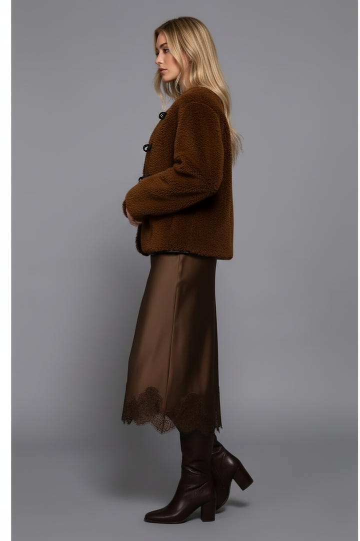 Side view of blonde model in jacket and skirt showing slit