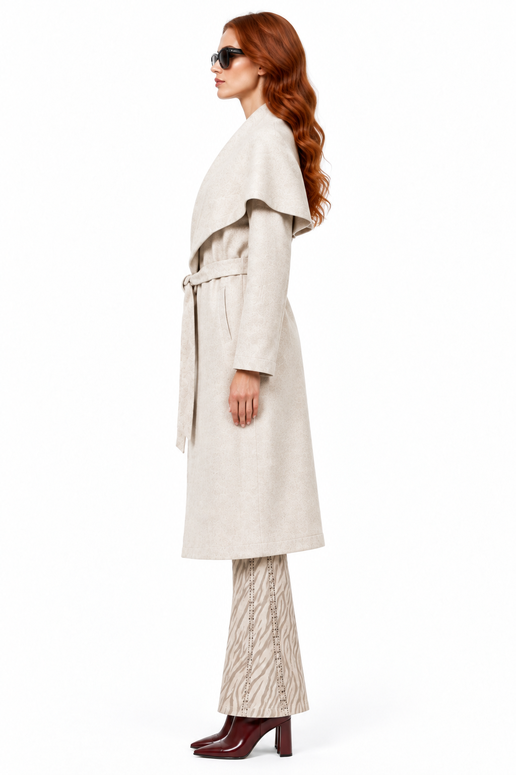 Side view of the redhead model in the coat and Beciga pants