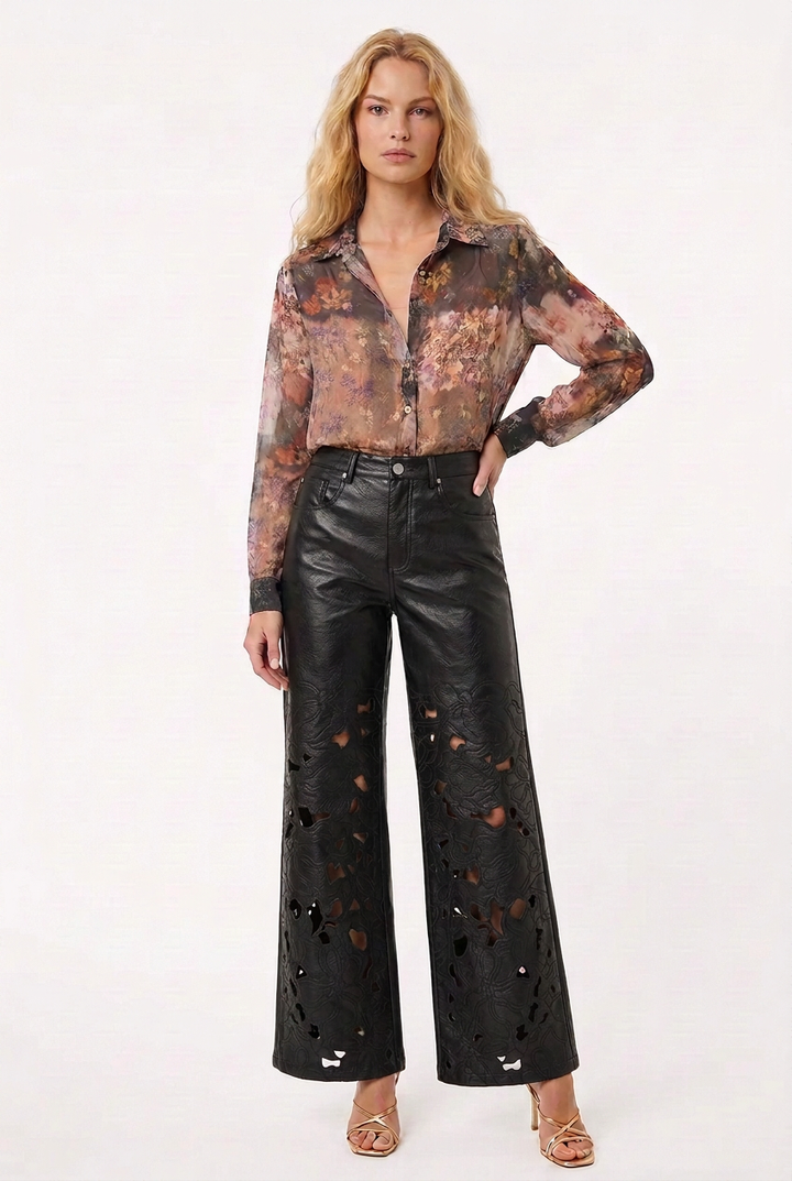 Tricia wearing the floral blouse with a French tuck and black floral-cutout pants